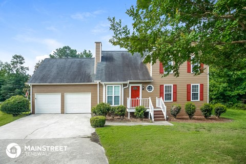 a house with a red door and a white garage door